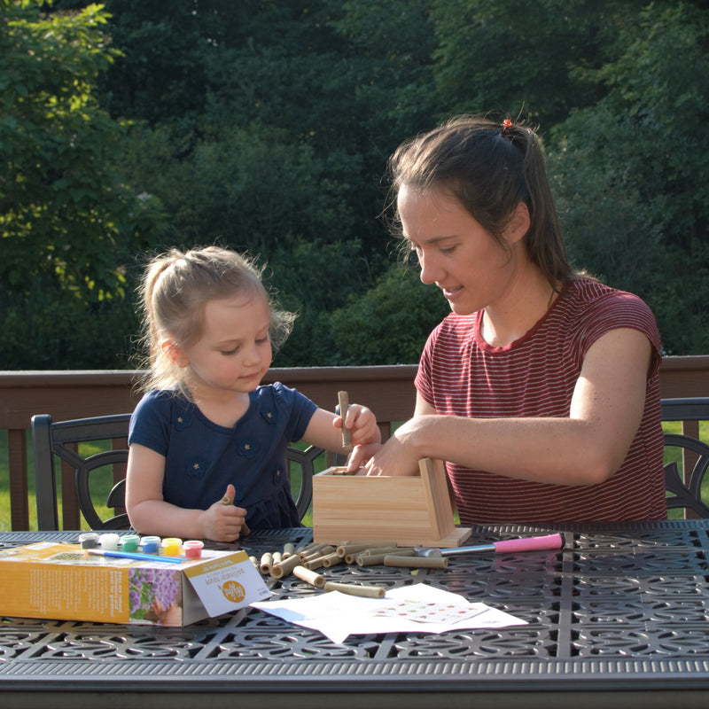 Load image into Gallery viewer, mother and child assembling My First Pollinator House
