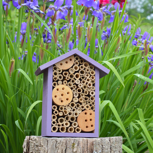 Better Gardens Bee House sitting on stump in garden