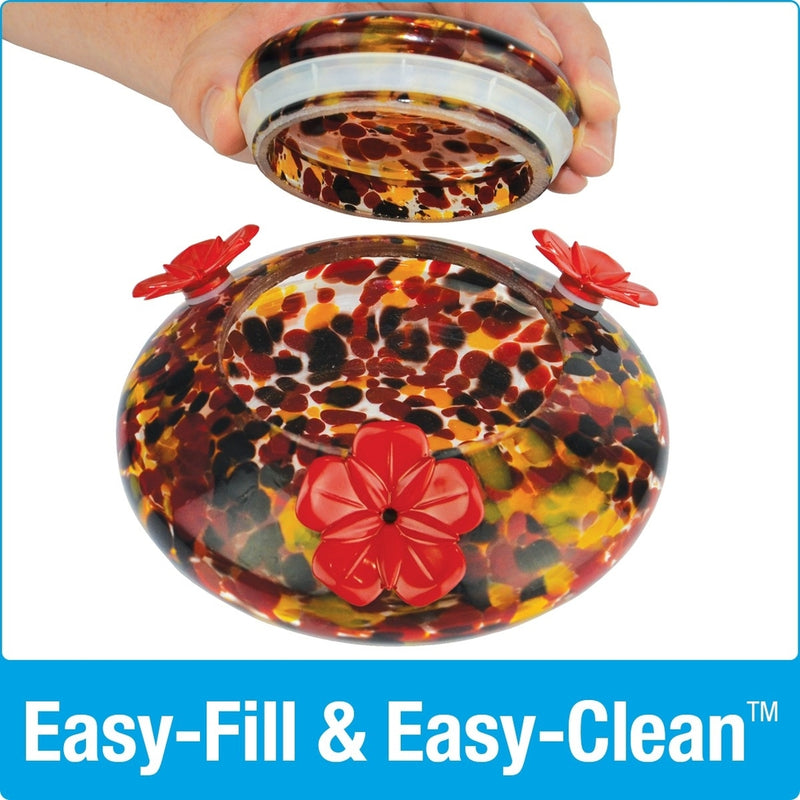 Load image into Gallery viewer, hand lifting the glass lid off of the base dish for easy fill and easy clean on Nature's Way hand blown glass garden hummingbird feeder