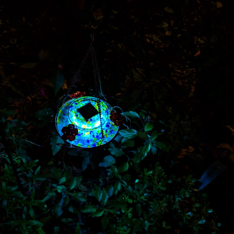 Load image into Gallery viewer, Top view of the Nature's Way Illuminated Hummingbird hand blown glass Feeder illuminated at night