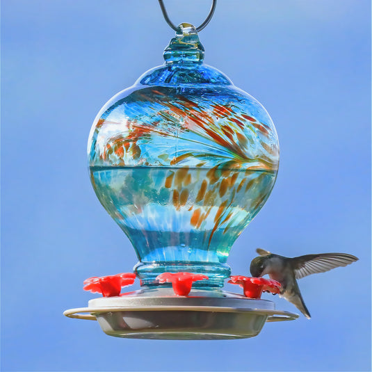 hummingbird feeding from the Artisan Gravity Hummingbird Feeder - Sunny Day