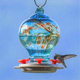hummingbird feeding from the Artisan Gravity Hummingbird Feeder - Sunny Day