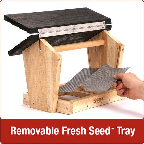 Demonstration of removable fresh seed tray on Nature's Way 4 QT Hopper cedar bird Feeder with two Suet Cages