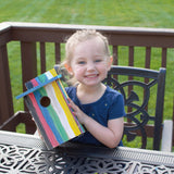 child holding finished My First Bird House w/ Viewing Window