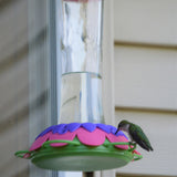 hummingbird feeding from the Nature's Way So Real Gravity Hummingbird Feeder in Purple Fuchsia