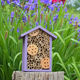 Better Gardens Bee House sitting on stump in garden