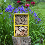 Better Gardens Deluxe Pollinator House sitting on stump in garden