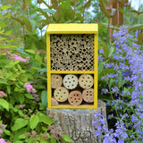 Better Gardens Deluxe Pollinator House sitting on stump in garden