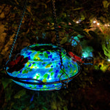 LED light illuminating the Nature's Way Illuminated Hummingbird hand blown glass Feeder at night
