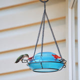 hummingbird feeding from Nature's Way hand blown glass garden hummingbird feeder